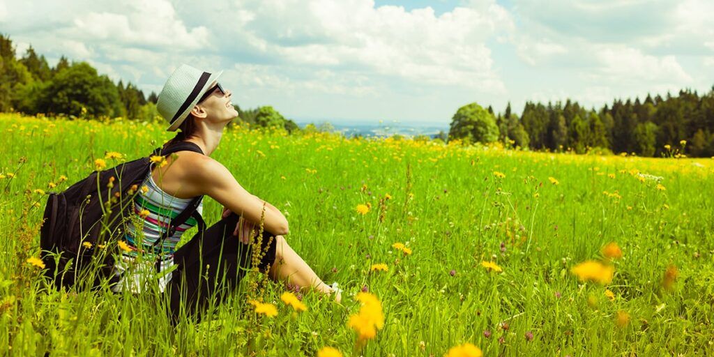 Difference between Hiking and Backpacking - Backpacker Meditating Outdoor Difference between Hiking and Backpacking - Young Woman Backpacker Enjoying Nature