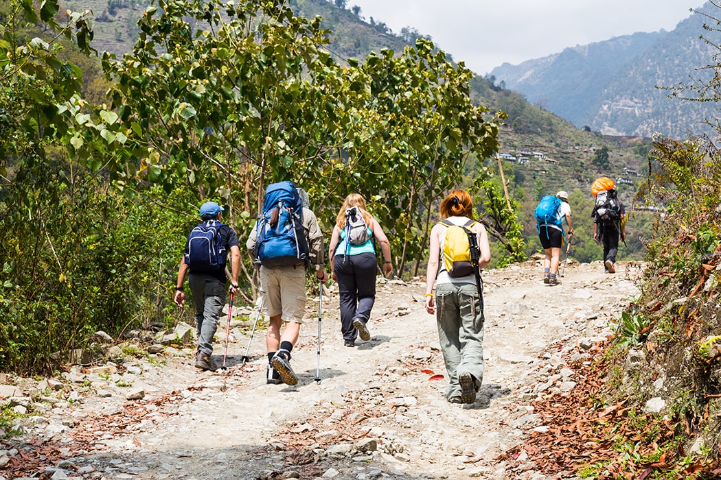 Hiking Backpack Recommendations — Group of People Trekking on a Dirt Road in Nepal.
