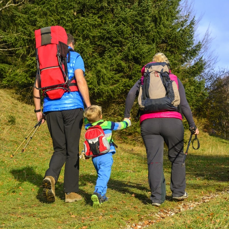 How to Choose a Hiking Backpack — Family Walking on a Trail.