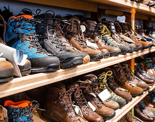 Many Pairs of Hiking, Trekking, and Mountaineering Boots in a Store.