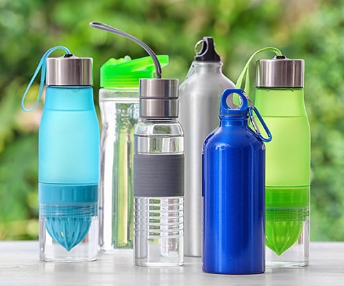 What to Look for in a Water Bottle — Sports Water Bottles on Table against Blurred Background.