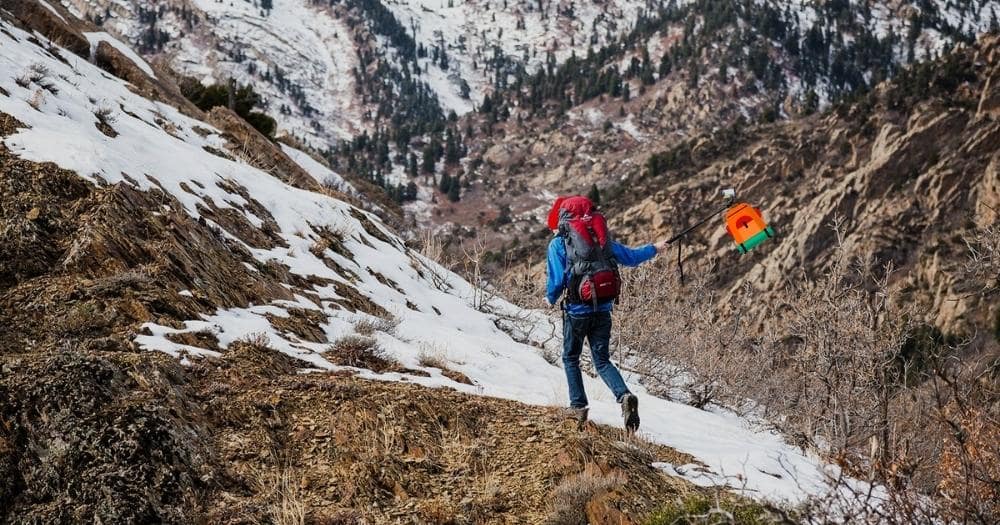 Best 60 Liter Backpack — Hiker Climbing a Mountain.