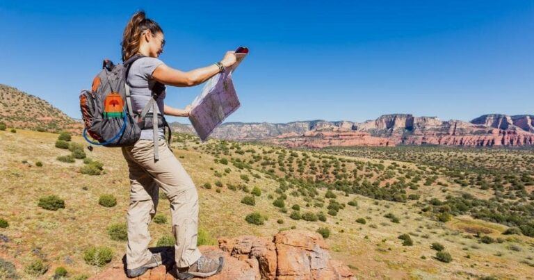 Best Hiking Backpack for Women — Young Woman Looking at a Map in a Canyon.