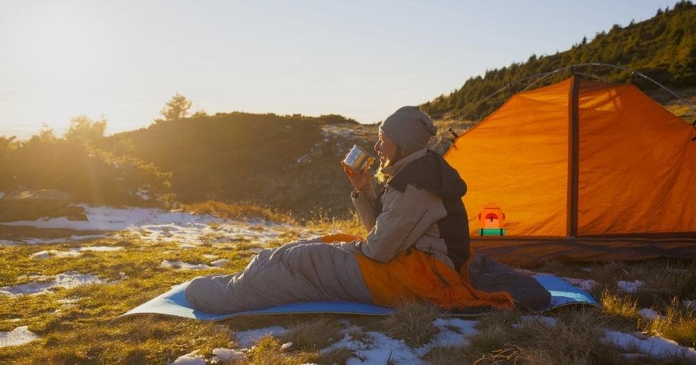 Choose a Sleeping Bag — Girl in a Sleeping Bag Sitting Near a Tent.