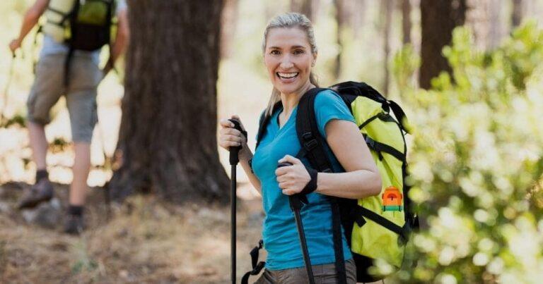 Cool Hiking Backpacks — Woman Smiling and Hiking in the Wood.