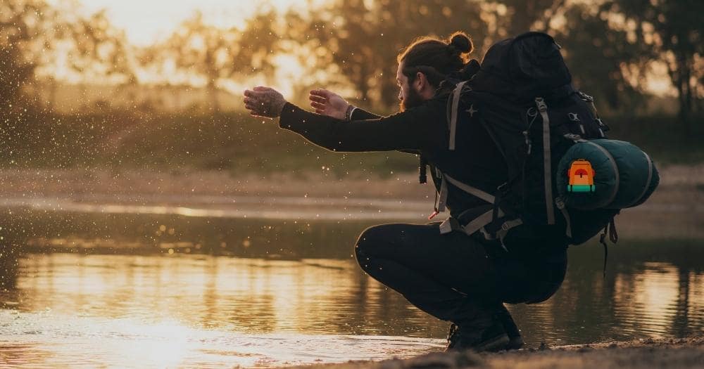 Hiking Backpack ONEPACK 50L Review — Backpacker at Lake Playing with Water.