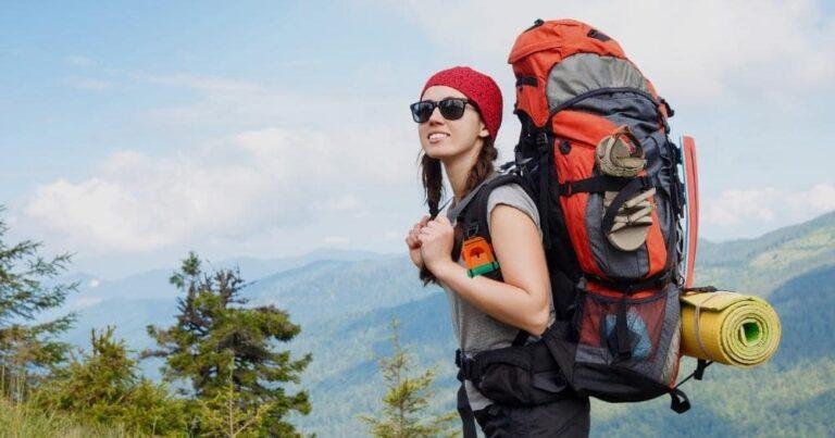 How to Pack a Hiking Backpack — Woman Traveler with Backpack Hiking in Mountains.