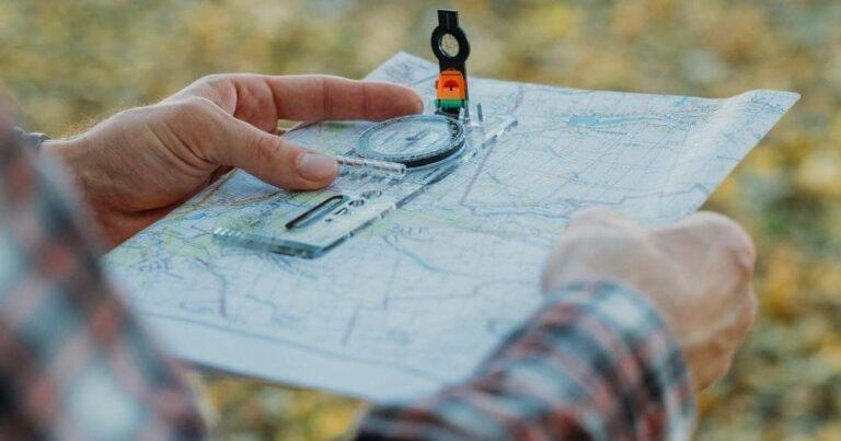 How to Use a Compass When Hiking — Man Holding Compass and Map.