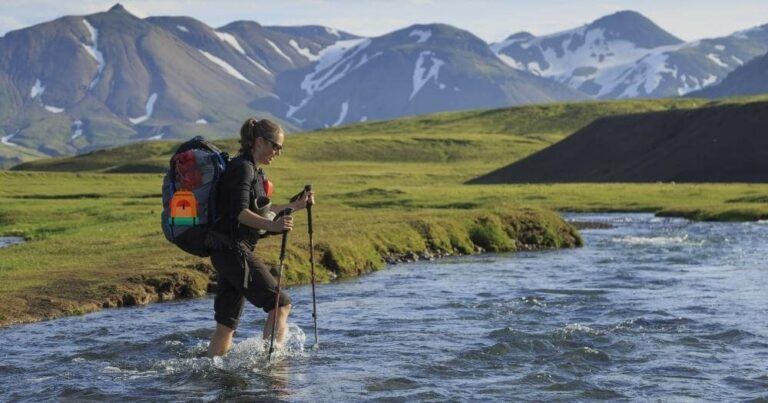 Which Hiking Backpack Should I Buy — Female Hiker Crossing a River on the Laugavegur Trail, Iceland.